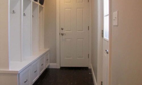 white cabinets and door in a hallway