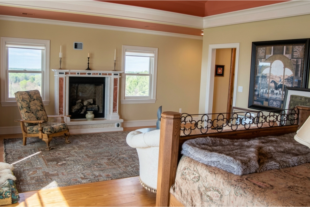 Warm beige painted bedroom with white trim and a painted tray ceiling.