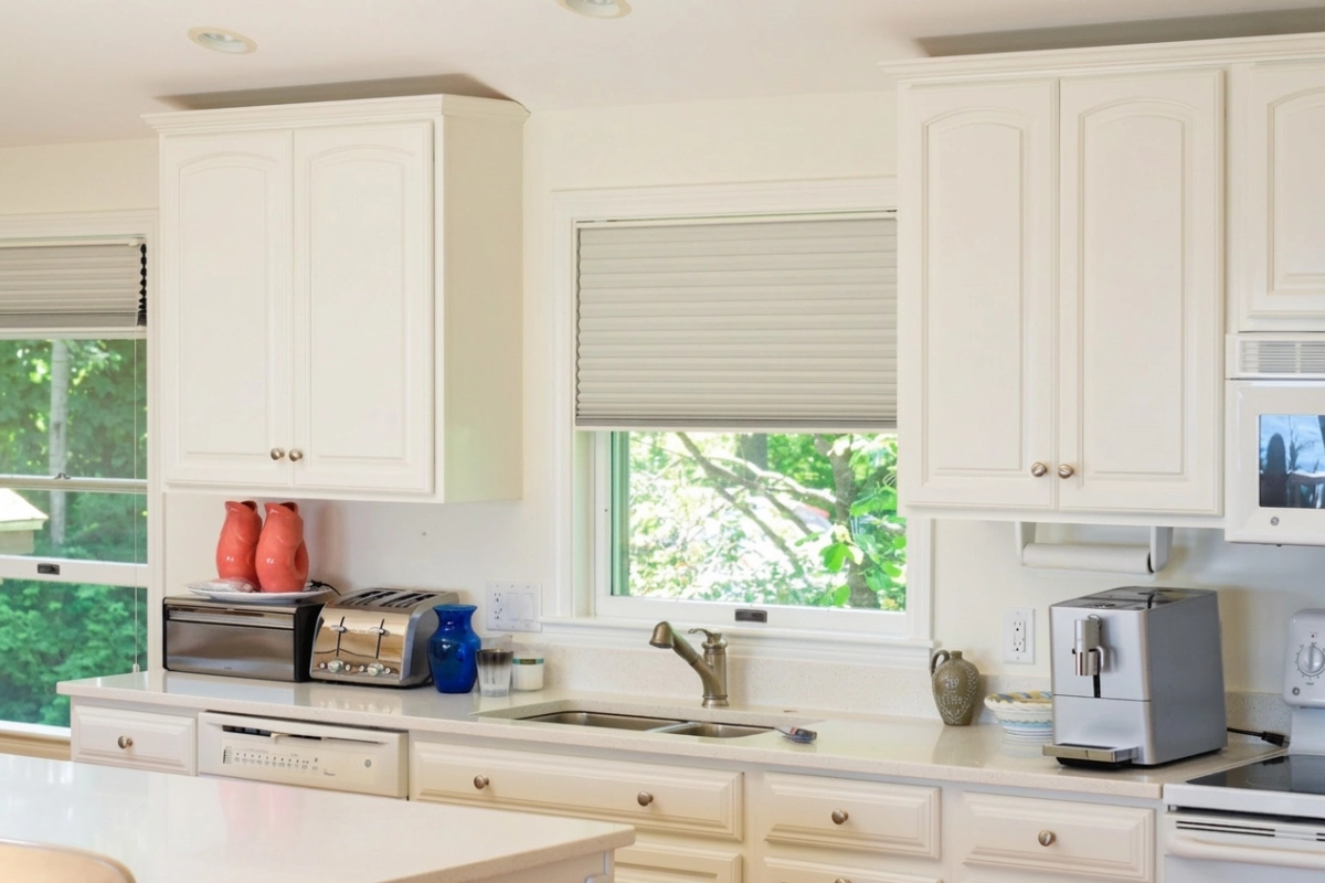 white modern cabinets with home appliances on kitchen island.